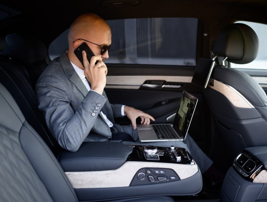 Passenger doing business inside Executive car.